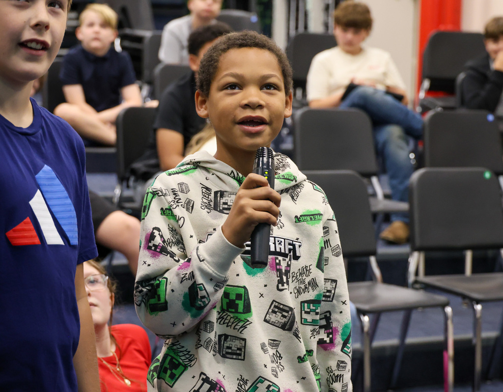 BMS student uses a microphone to perform a short play