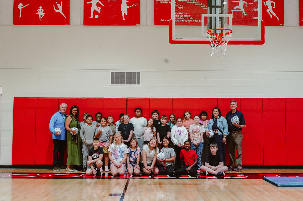 Group photo with soccer ball donations.