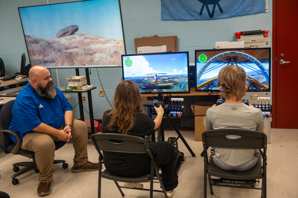 Students use airplane simulator.