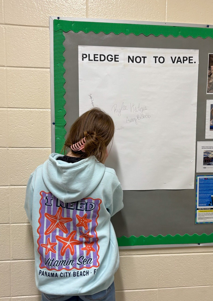 Student signs the pledge not to vape.