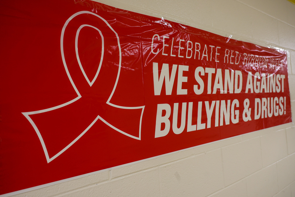 Red banner that is in hanging in the hallway that reads "Celebrate Red Ribbon Week. We Stand Against Bullying & Drugs!" There is a red ribbon on the left side of the banner.