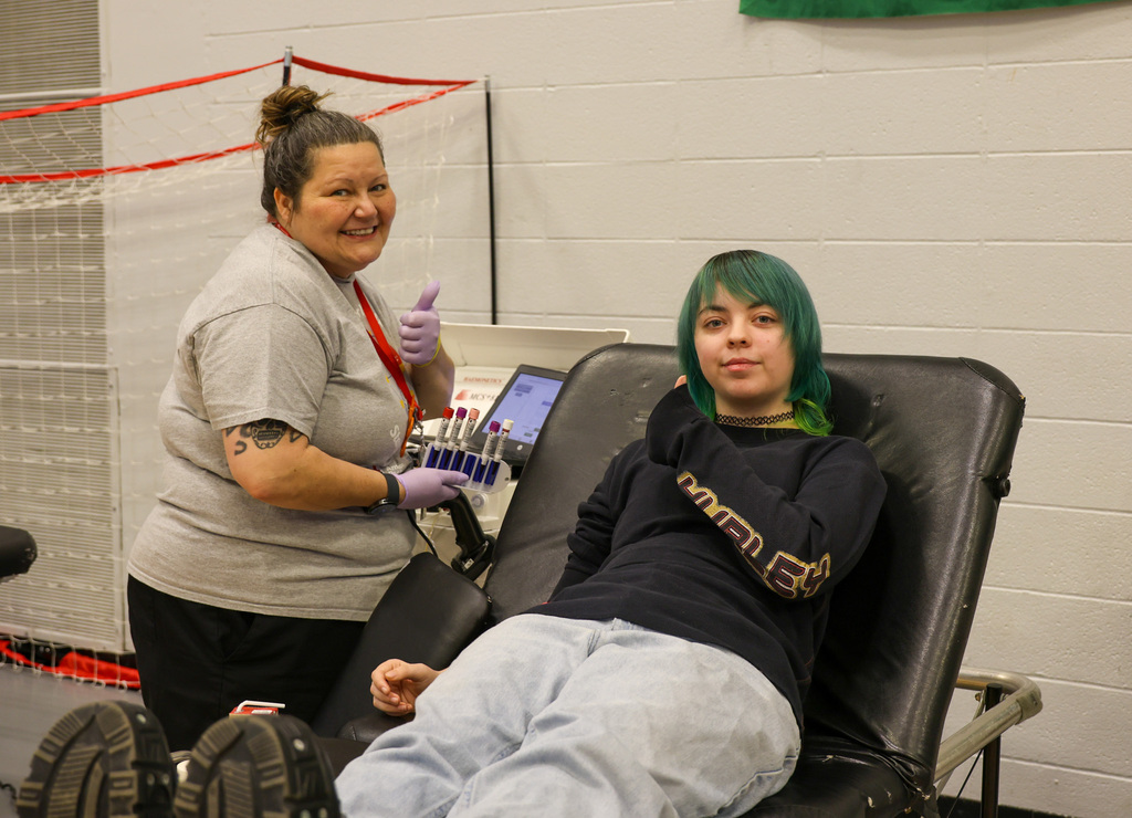 American Red Cross staff member (left) and WHHS student (right) smile and give a thumbs up after completing a blood donation.