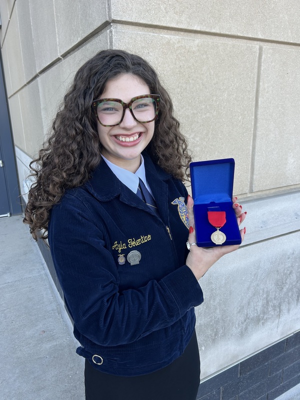 Ayla Tolentino holds her silver medal.