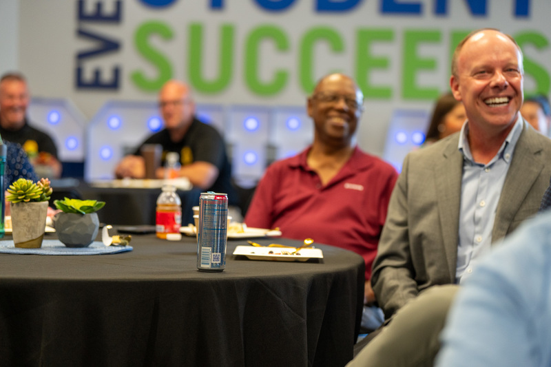 Key Communicators members laughing in board room