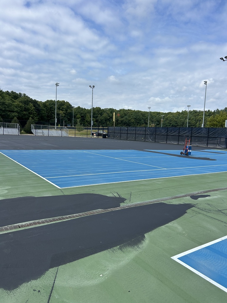Outdoor tennis courts with a blue sky