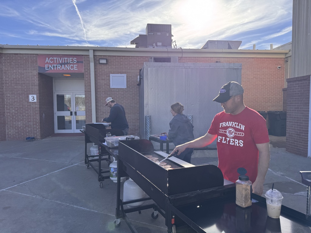beef boosters grilling hamburgers outside for school lunch