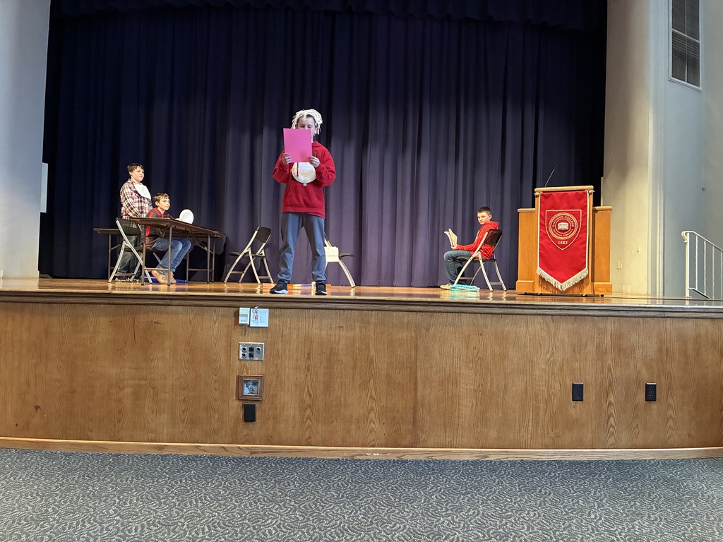 future problem student at front of stage reading paper