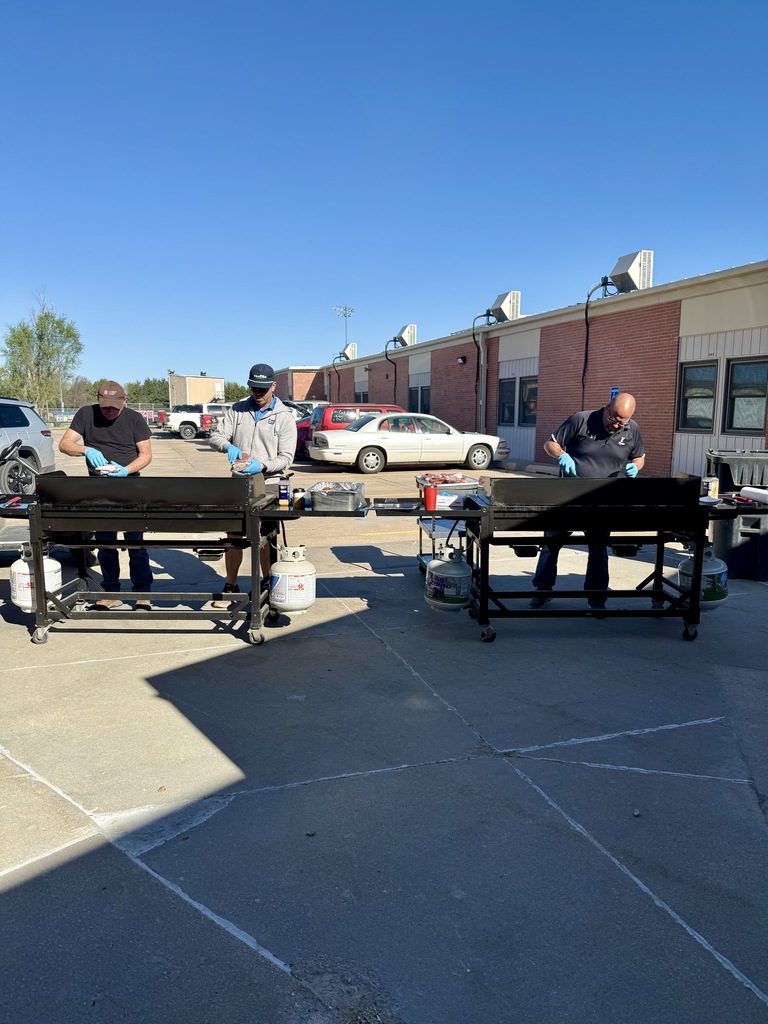 Picture of volunteers grilling hamburgers for school lunch.  Meat provided by our Franklin Beef Boosters. 