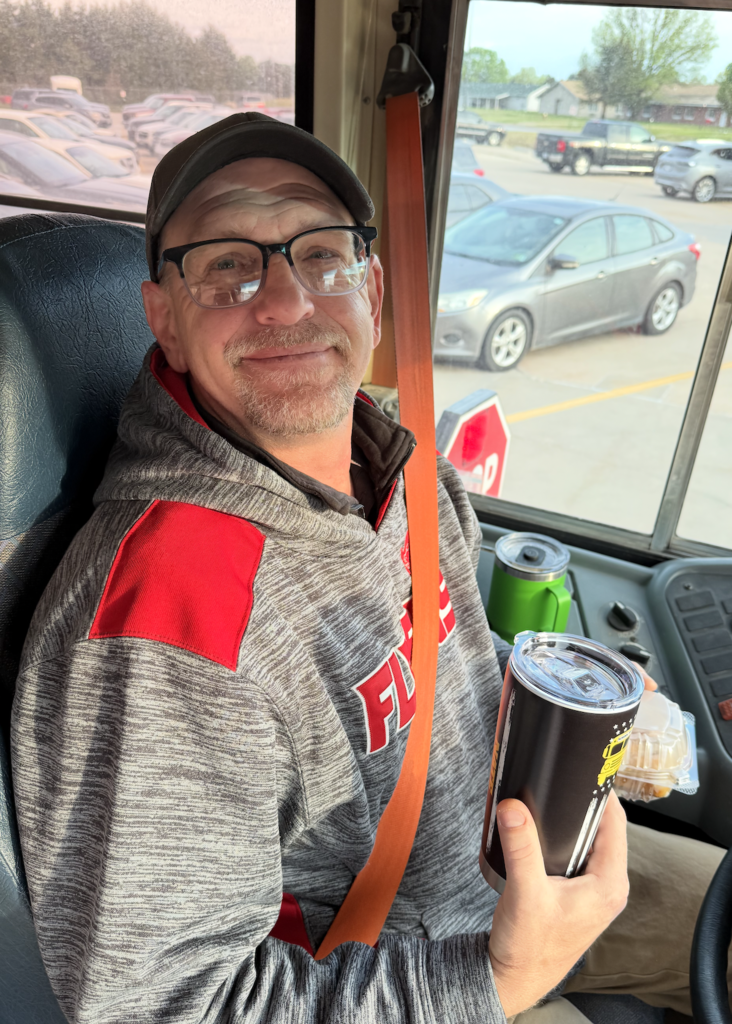 Nate Liechti, Franklin Public School bus driver in the drivers seat of his bus. 