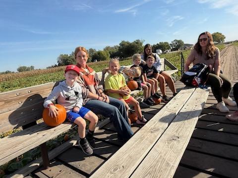 Students riding on the hay rack ride. 