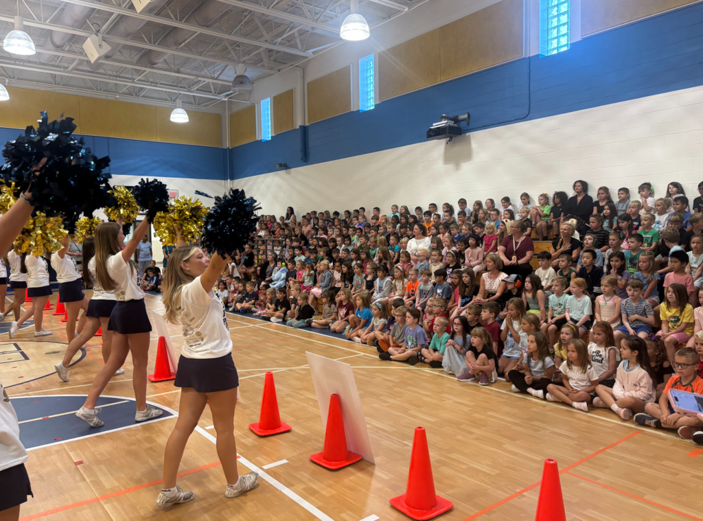 Franklin Regional Cheerleaders stand in front of a Primary School audience to perform during an assembly.
