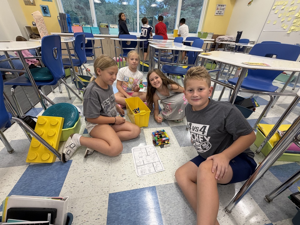 Students at the Franklin Regional Intermediate School show off their LEGO creation alongside their storyboard.