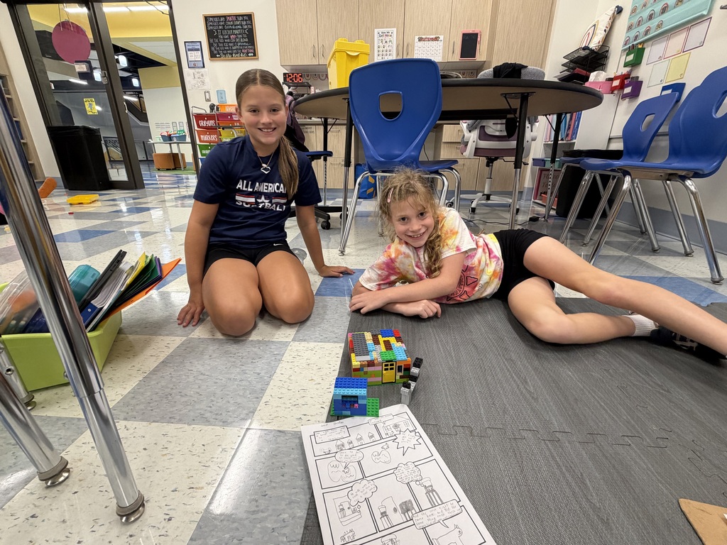 Students at the Franklin Regional Intermediate School show off their LEGO creation alongside their storyboard.