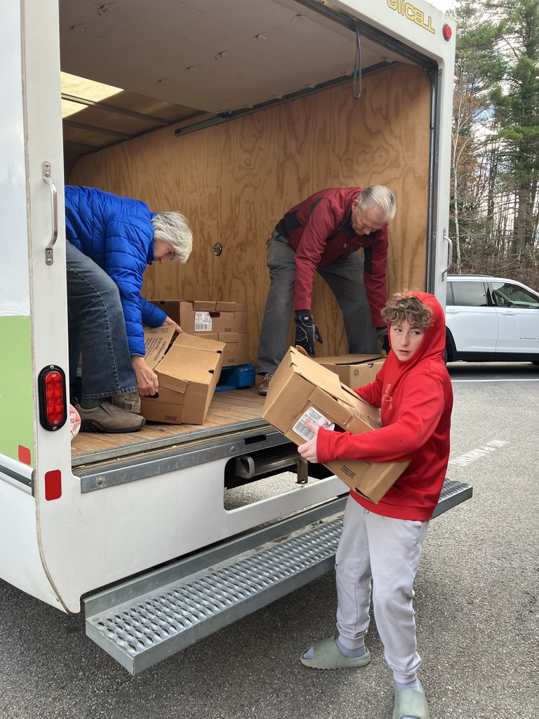 Middle School boy, red shirt, unloading turkeys from a box truck
