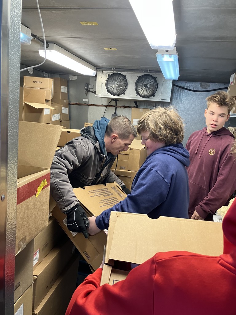 Boys unloading turkeys from a box truck