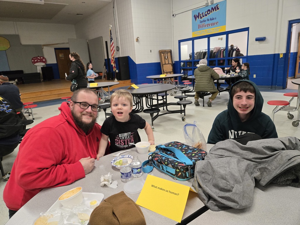 father and two sons smiling at a table