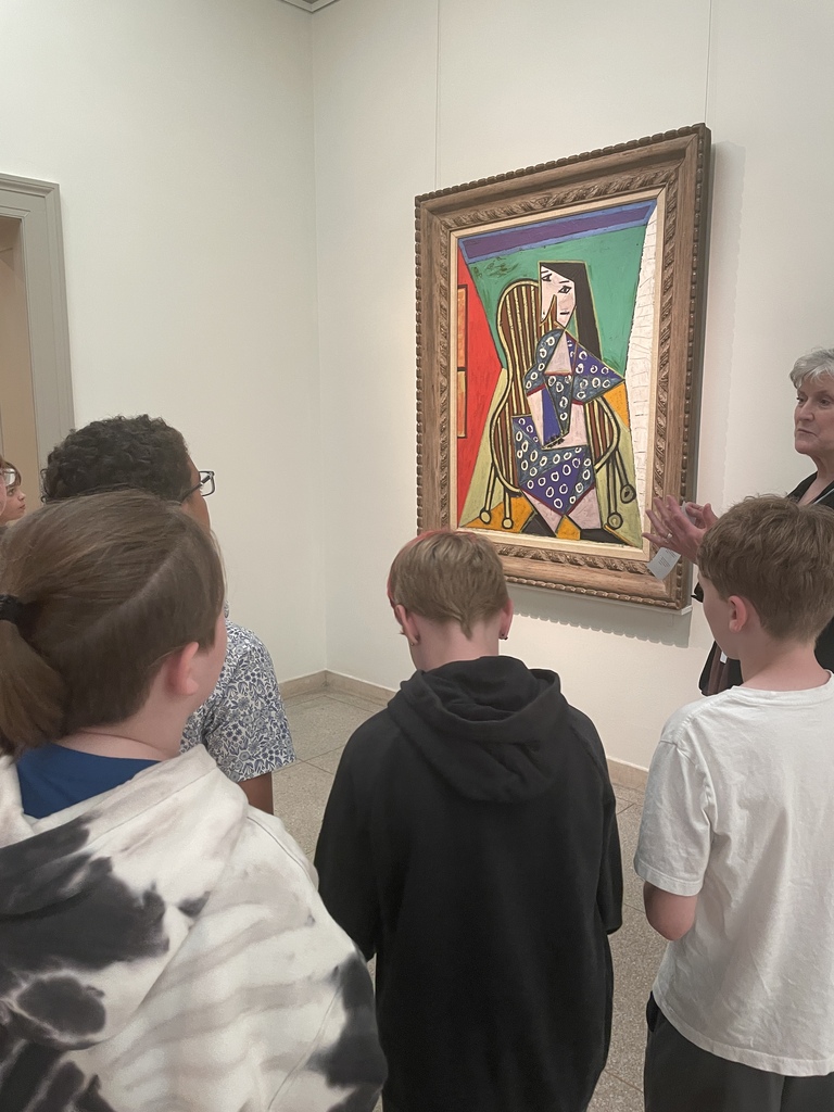 Students look at a Picasso during a guided tour.