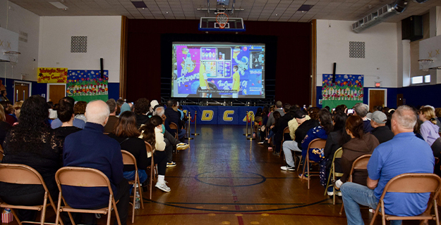 Community members watching film screening.