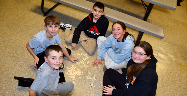 Students sitting on carpet.