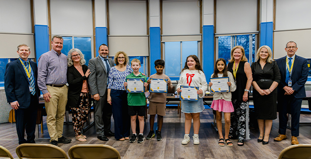 Board members standing with award winners.