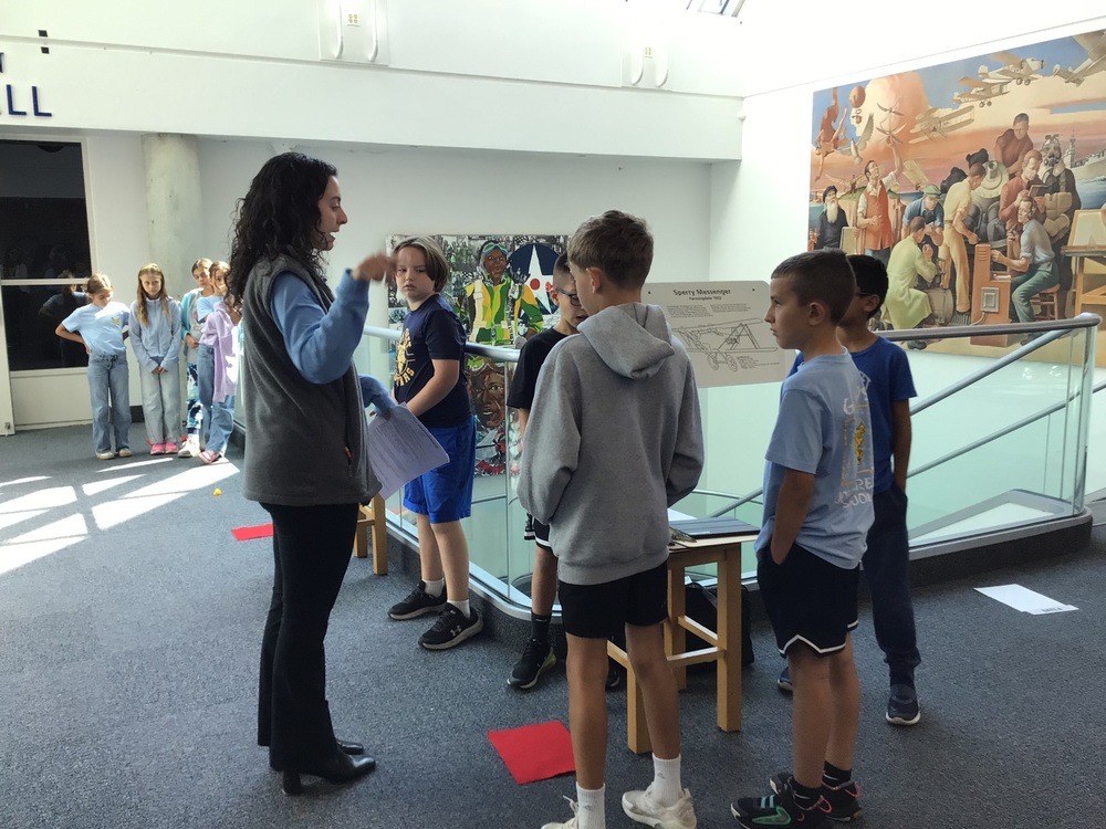 students at a museum with the guide
