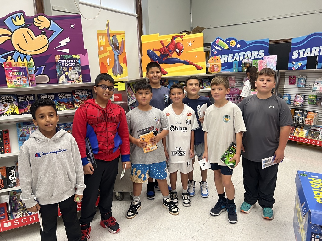 kids holding books at a bookfair