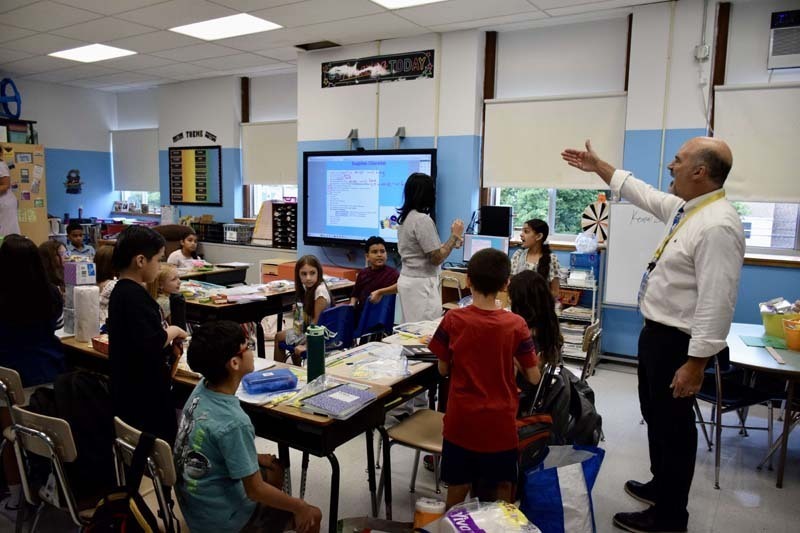 Teacher smiling with students.