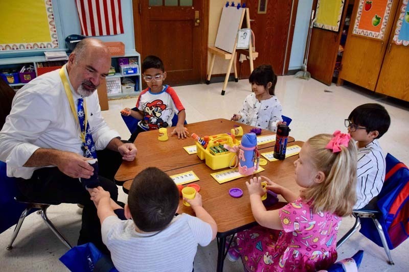 Teacher smiling with students.