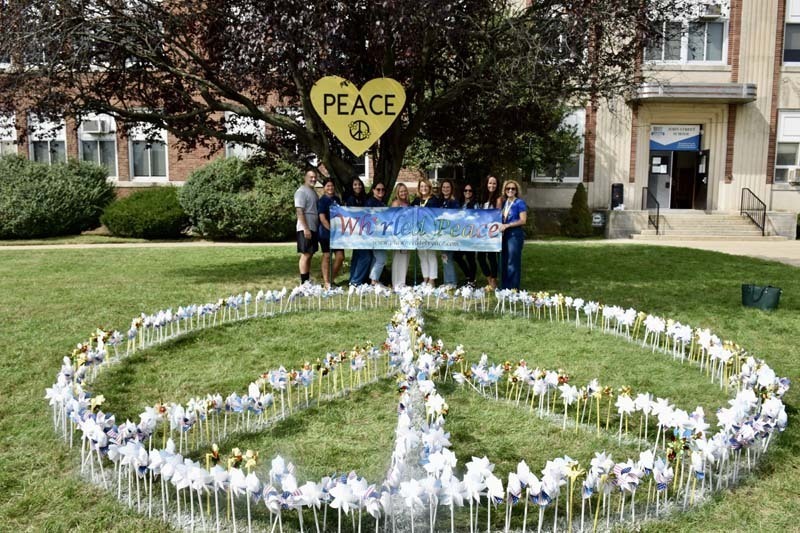 Peace sign made out of student artwork.