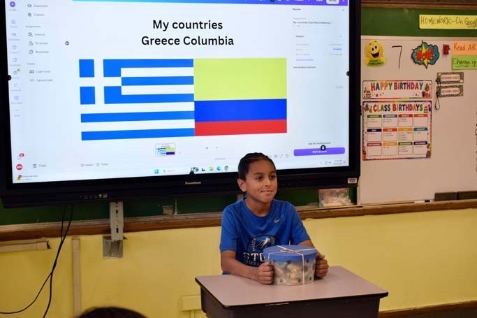 Student giving presentation at front of class.