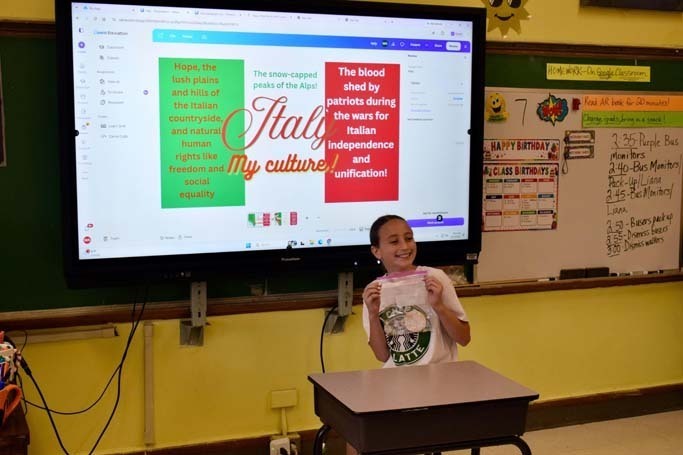 Student giving presentation at front of class.