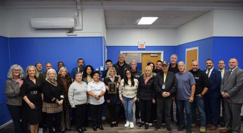 Students smiling with board members.