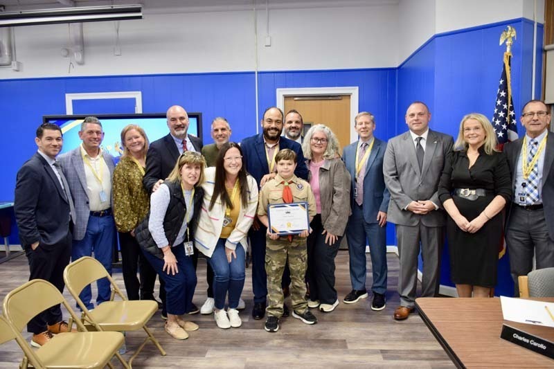Students smiling with board members.