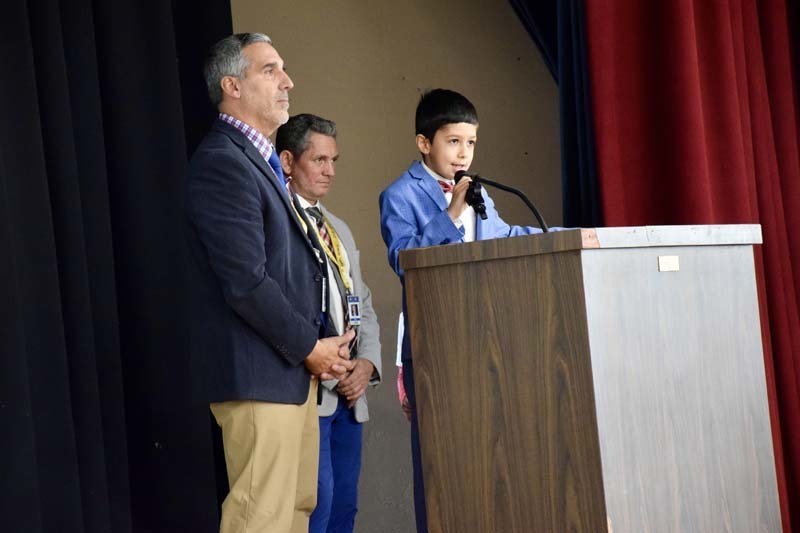 Student speaking at podium.