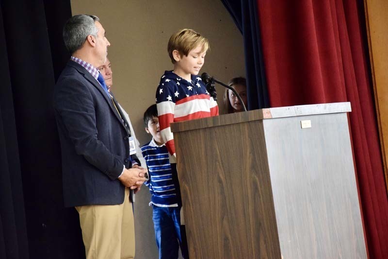 Student speaking at podium.