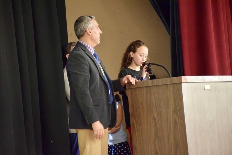 Student speaking at podium.