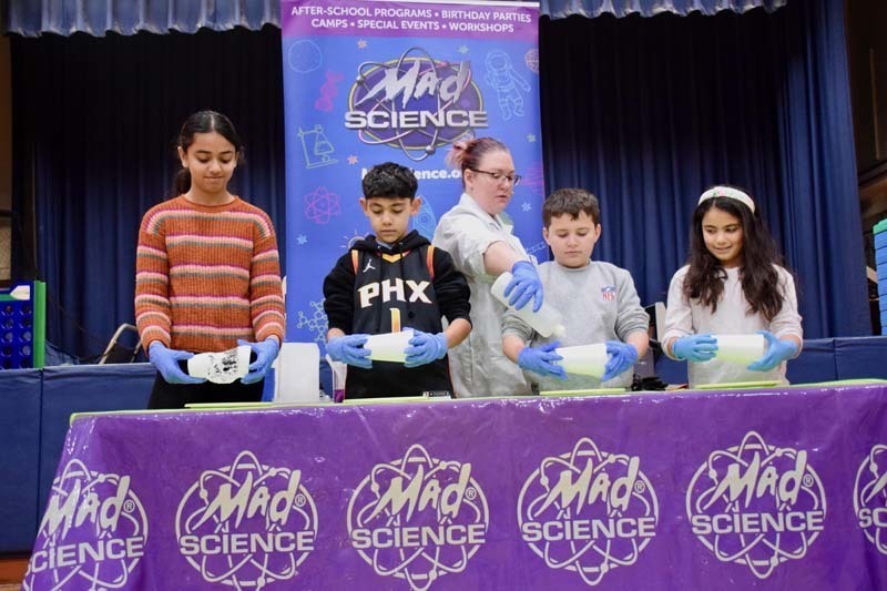 Students with "mad scientist" on stage.