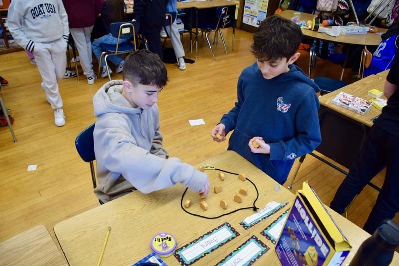 Students smiling while building with blocks.