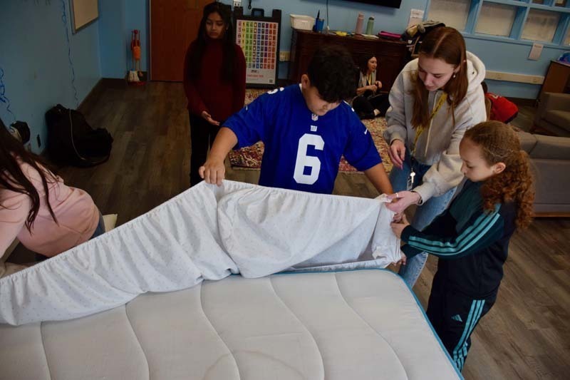 Student examining sheets.