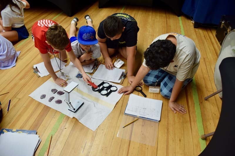 Students working on projects on the floor.