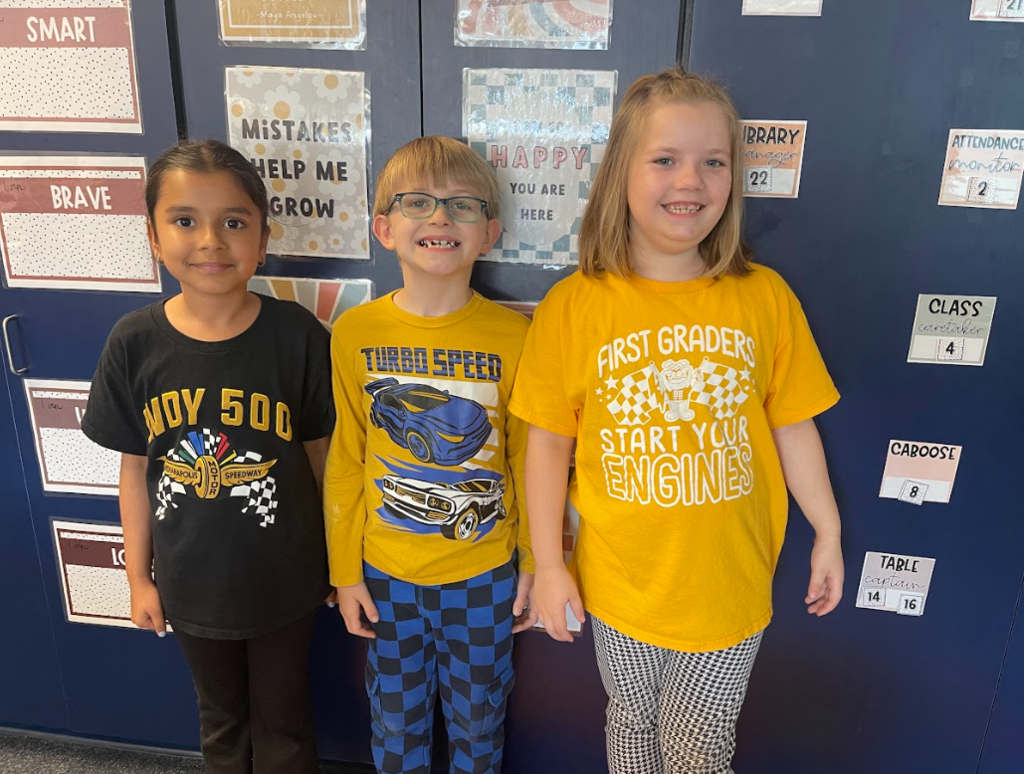 3 students smiling