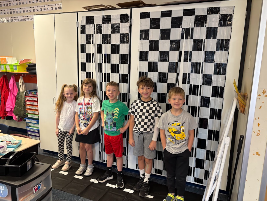Group of students smiling in front of checkered background