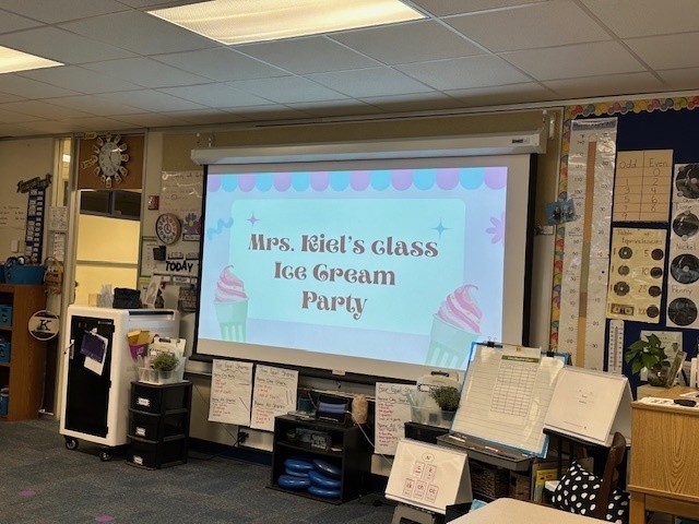 projection sign that says "Mrs Kiel's class ice cream party"