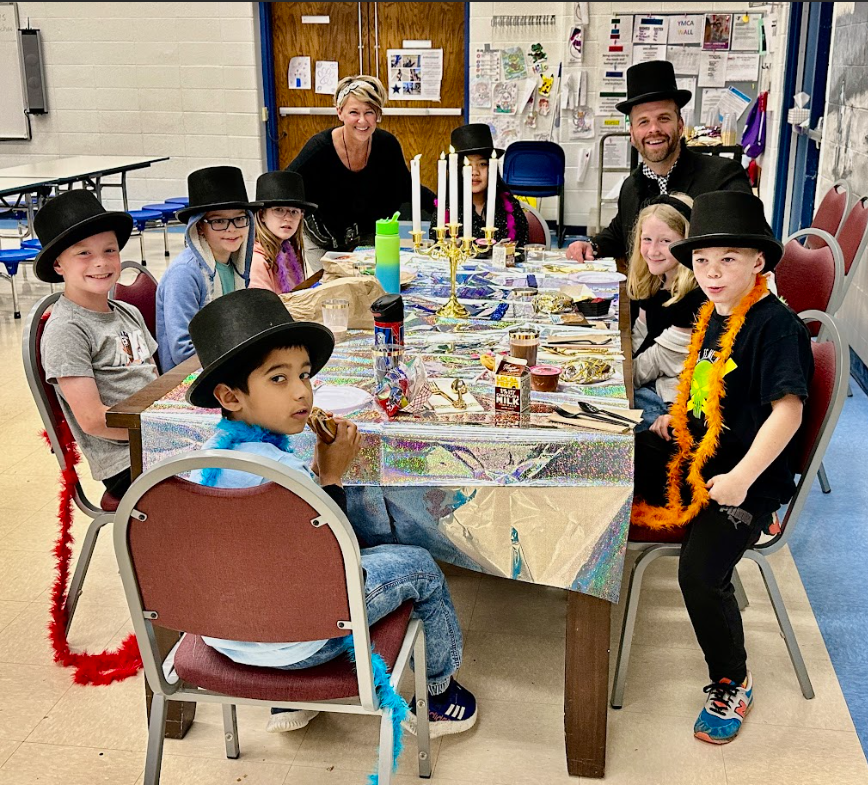 Students smiling with Mrs. Huff and Mr. Koomler
