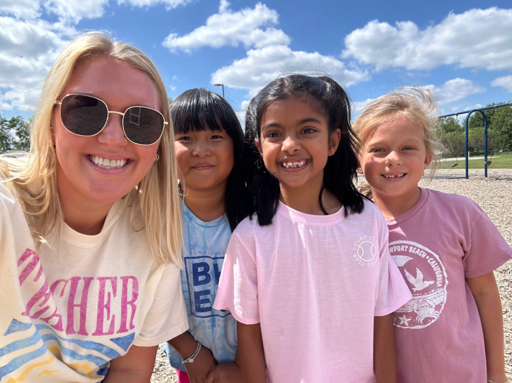 Teacher smiling with students