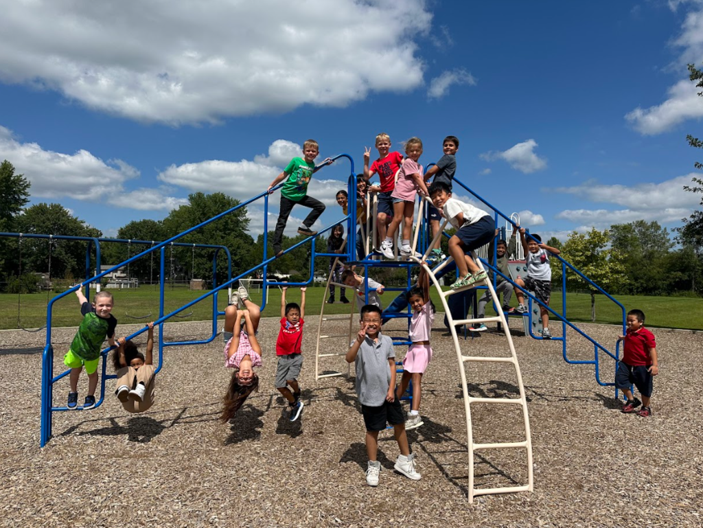 2nd grade students playing on climbing equipment