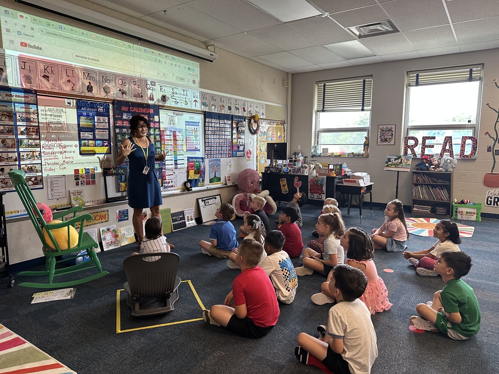 Kindergarten students sitting on carpet 