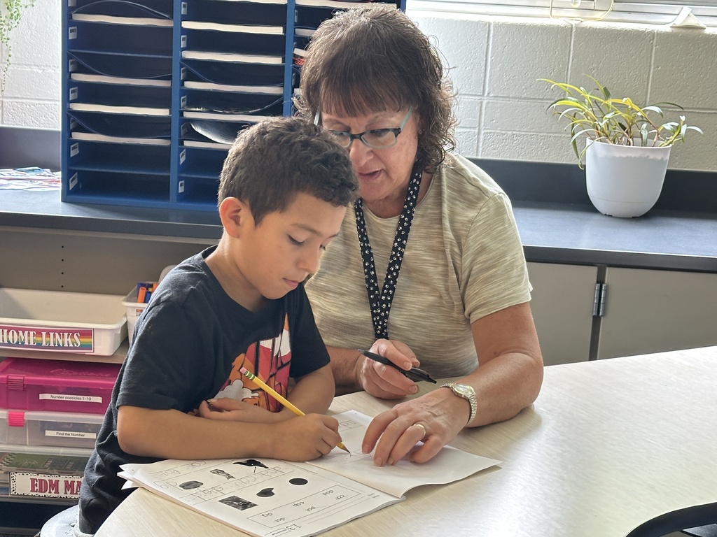 student and teacher doing school work one on one