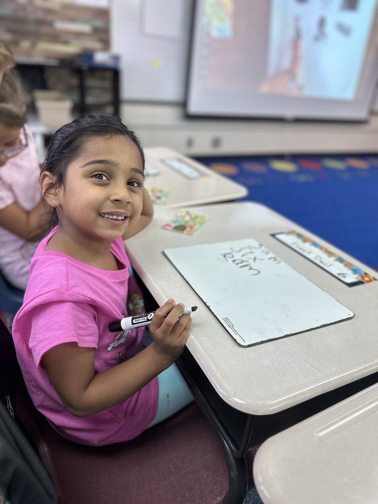 First grade student doing class work