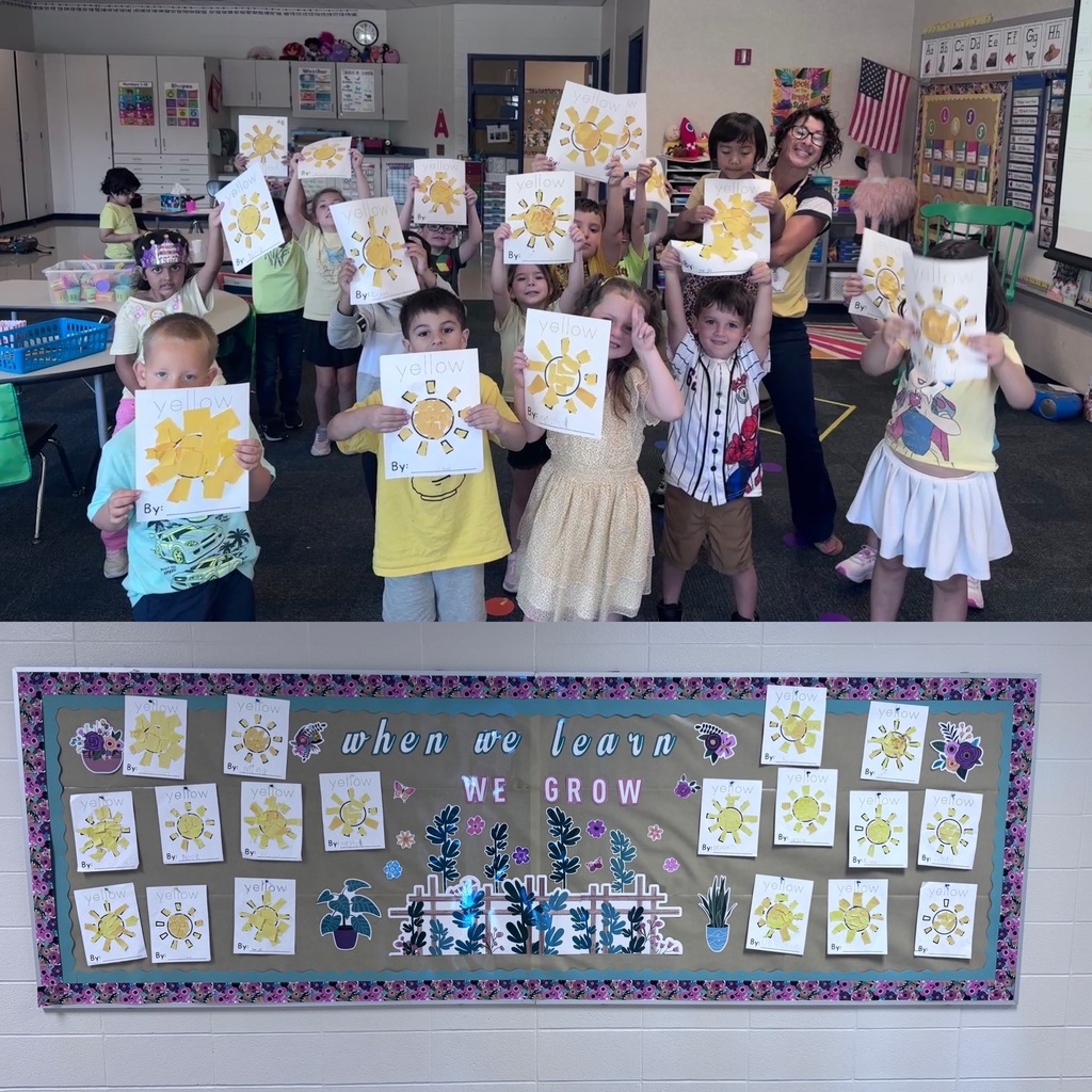 Kindergarten students holding up yellow suns that they made out of paper